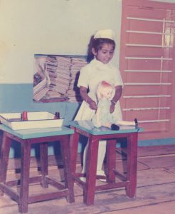 Me, aged 4, as a nurse treating a doll